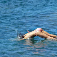 Demi Harman showing off her curvy body in a striped red bikini at the beach in S