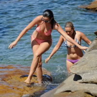 Demi Harman showing off her curvy body in a striped red bikini at the beach in S