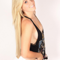 Ashley Vallone flaunts her beauty in a black tank top and white shorts