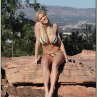 Busty blonde Eve Laurence strips from bikini and spreads shaved slit