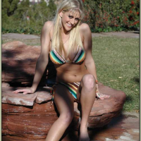 Busty blonde Eve Laurence strips from bikini and spreads shaved slit