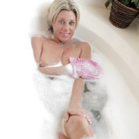 Sassy mature blonde with massive saggy tits taking foamy bath
