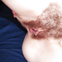 Fair skinned babe Timea Bella undresses and shows hairy pussy
