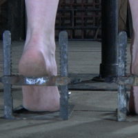 Delirious Hunter metal bound with bdsm toys and fire her bare feet spanked