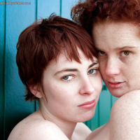 Redhead teens Maria S and Tricia L licking nipples and hairy cunts outdoors