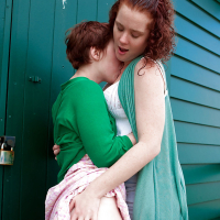 Redhead teens Maria S and Tricia L licking nipples and hairy cunts outdoors