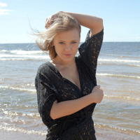 Sensual blonde babe Viola unveils her big tatas on the beach