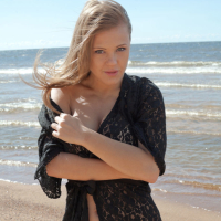 Sensual blonde babe Viola unveils her big tatas on the beach