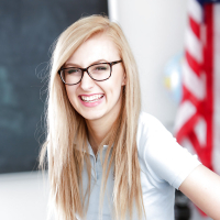 Young blonde nerd in glasses Alexa Grace posing in schoolgirl uniform