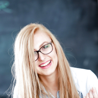 Young blonde nerd in glasses Alexa Grace posing in schoolgirl uniform