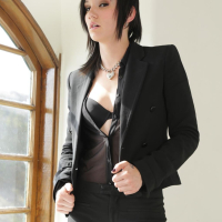 Inked Nikki Hearts fingers herself by a Window