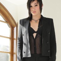 Inked Nikki Hearts fingers herself by a Window
