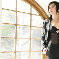 Inked Nikki Hearts fingers herself by a Window