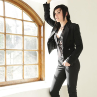 Inked Nikki Hearts fingers herself by a Window