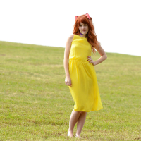 Amarna Miller poses in a beautiful yellow dress while outside