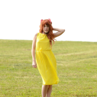 Amarna Miller poses in a beautiful yellow dress while outside
