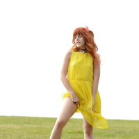 Amarna Miller poses in a beautiful yellow dress while outside