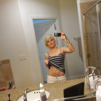 Young blonde hottie Ash Hollywood taking selfies in mirror while undressing