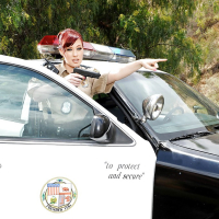 Redheaded pornstar Jessica Ryan gives interracial bj outside in cop uniform