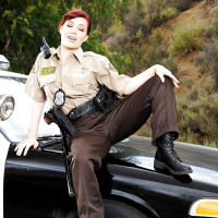 Redhead pornstar babe Jessica Ryan strips off police uniform outdoors