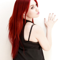 Tattooed hot redhead Jessica Ryan strips to bare hard nipples and spread ass