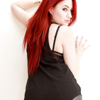 Tattooed hot redhead Jessica Ryan strips to bare hard nipples and spread ass