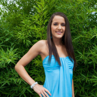 Cute girl Adriana Brill lifts up her blue dress to show her shaved pussy