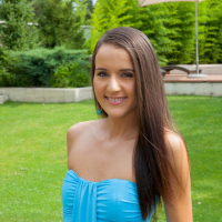 Cute girl Adriana Brill lifts up her blue dress to show her shaved pussy