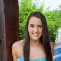 Cute girl Adriana Brill lifts up her blue dress to show her shaved pussy