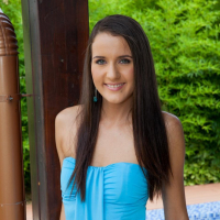 Cute girl Adriana Brill lifts up her blue dress to show her shaved pussy