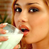 Beautiful Lenka Gaborova playing with milk in the kitchen
