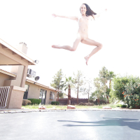 Leggy solo girl Lola Hunter poses outdoors beside swimming pool in bikini