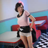 Classy hot MILF Veronica Avluv gives a peak on her pussy through her skirt