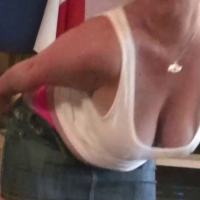 Busty wife Nikki Holland gives a titjob and rides in reverse