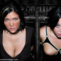 Claire Adams and Alexa Jordan together in leather strap bondage