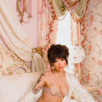 Tattooed model Emma Jade wearing hot garters with stockings