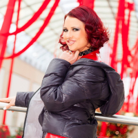 Lara Larsen posing in red Latex for Christmas