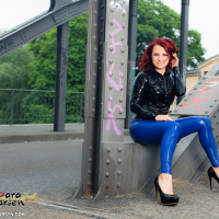 Lovely Lara Larsen posing outdoors in blue Pants