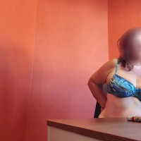Chubby amateur girl in lingerie sitting by the desk