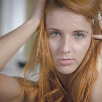 Roberta Bertis red hair falls on her tiny tits and shaved twat becomes wet