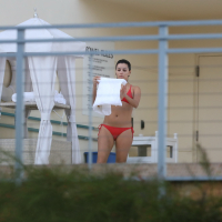 Eva Longoria shows off her round ass in a skimpy red bikini at the pool in Miami