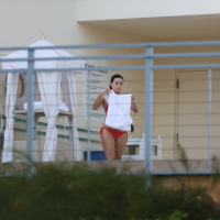 Eva Longoria shows off her round ass in a skimpy red bikini at the pool in Miami