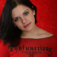 Sweet brunette teen Eva shows off her big boobs in a red top