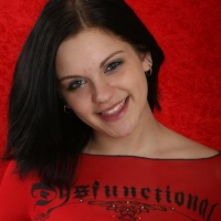 Sweet brunette teen Eva shows off her big boobs in a red top