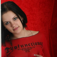 Sweet brunette teen Eva shows off her big boobs in a red top