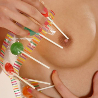 Armed blonde babe putting lollipop in pink pussy
