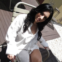Ravenhaired amateur Bella Reese demonstrating her goods outdoor