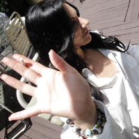 Ravenhaired amateur Bella Reese demonstrating her goods outdoor