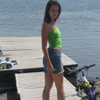 Gorgeous young brunette Melissa Doll teasing outdoors