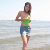 Gorgeous young brunette Melissa Doll teasing outdoors